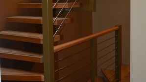 A spiral staircase with wooden steps and metal railings. - If boutique hotel (Amsterdam)