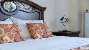 A neatly made bed with patterned pillows and a decorative headboard. - Elle Dimore in Lecce (Lecce)