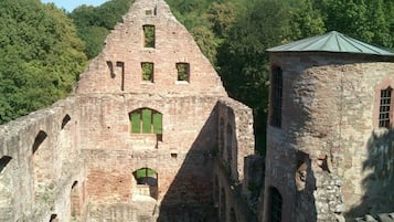 An ancient stone structure with arched windows and a small tower.