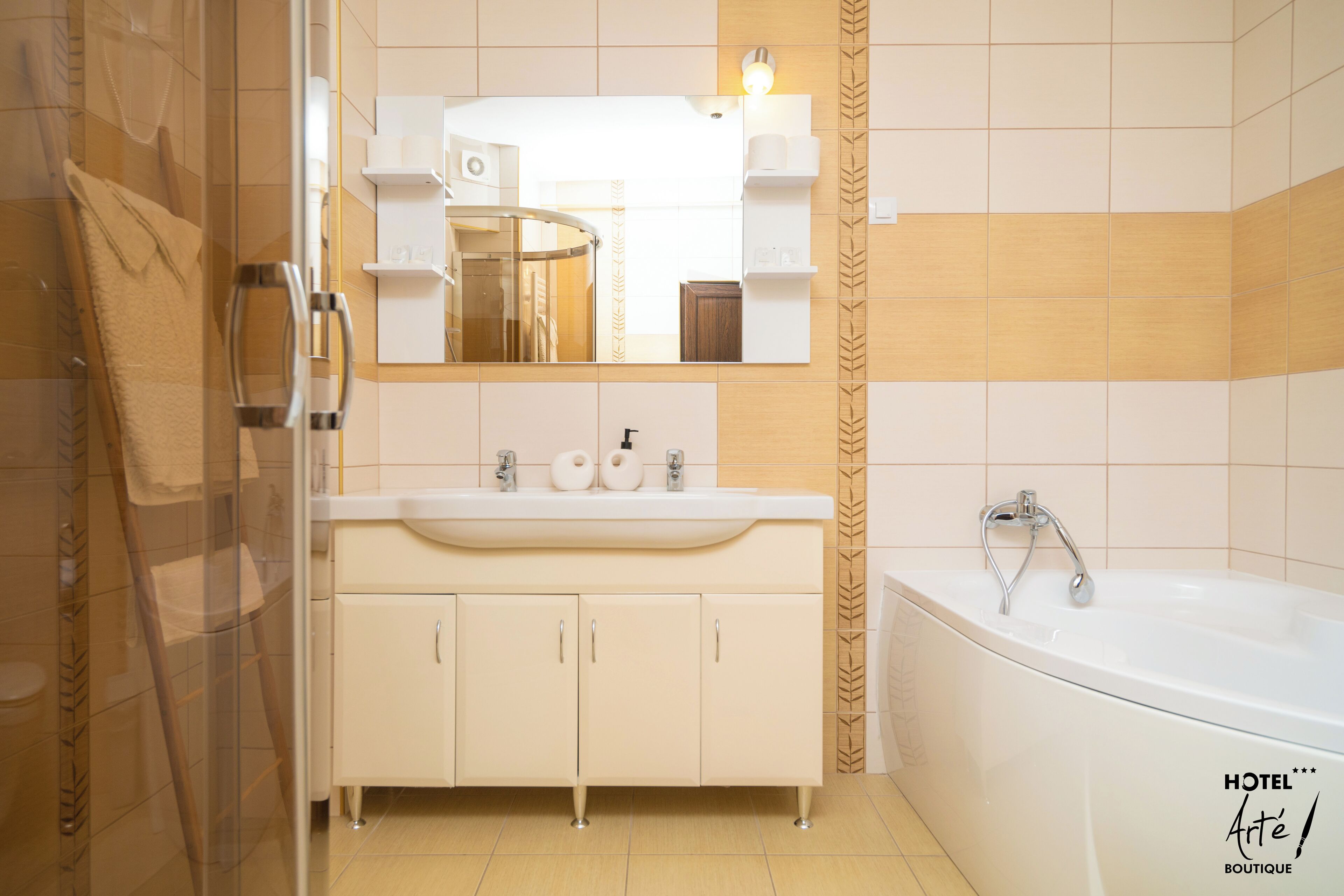 Un baño moderno con cabina de ducha de vidrio, un lavabo blanco con espejo y una bañera con ducha.
