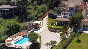 A large house with a swimming pool, a covered patio, and a well-maintained garden. - Villa St. Nicholas House, Family Friendly, Large Heated Pool, 300m to the beach. (Corfu)
