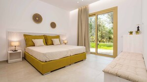A modern bedroom with a large bed, bedside tables, and a view of the outdoors.