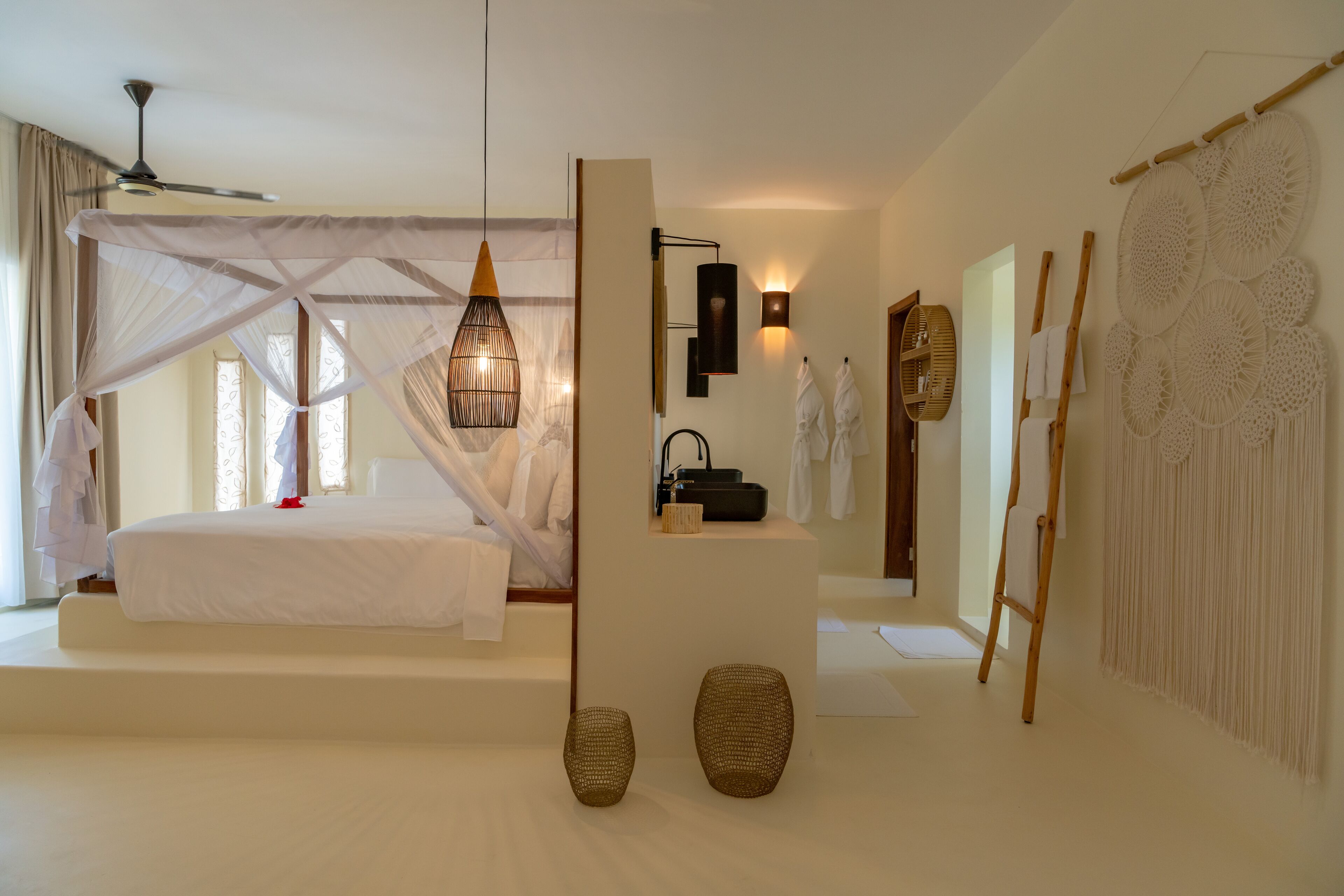 A modern bedroom with a bed, bedside table, and a large window with curtains.