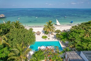 A resort with a swimming pool, beach, and ocean view. - Alma Boutique Hotel (Jambiani)