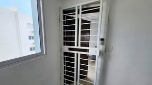 A room with a sliding door leading to a closet with multiple shelves.