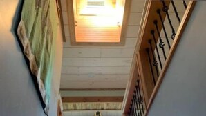 A wooden staircase with a view of the upper floor and a skylight. - 3 Valley View Barn Top Floor (Beaver Dams)