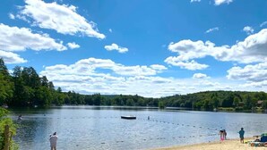 A lake with boats, a dock, and people on the shore. - Hupi House: A Peaceful, Wooded, Lakeside Sanctuary (Monterey)