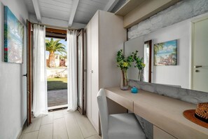 Relax in a serene space with a sliding door to an outdoor area, a long bench, and framed artwork on the walls.