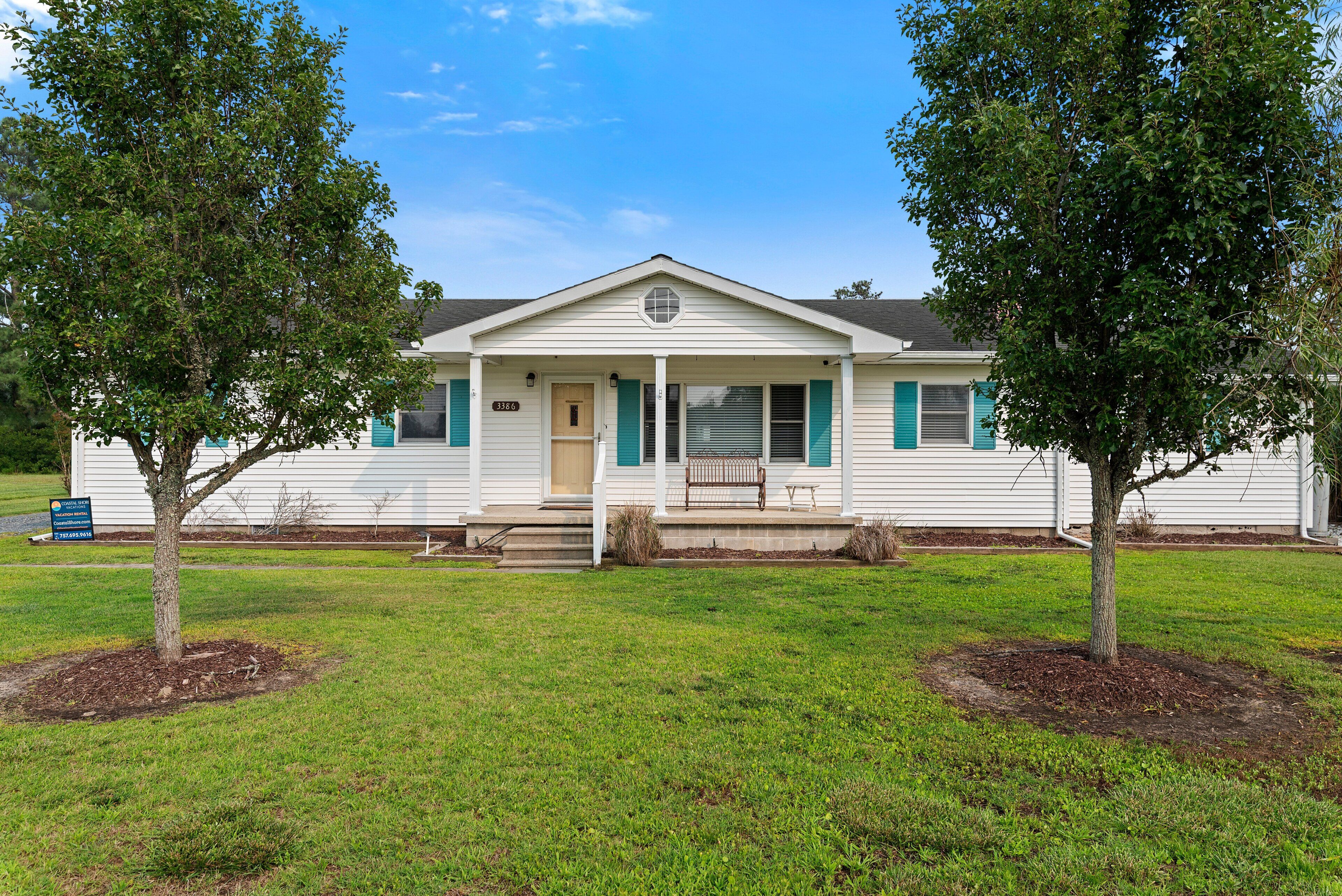 A single-story house with a front porch, a mailbox, and a lawn.