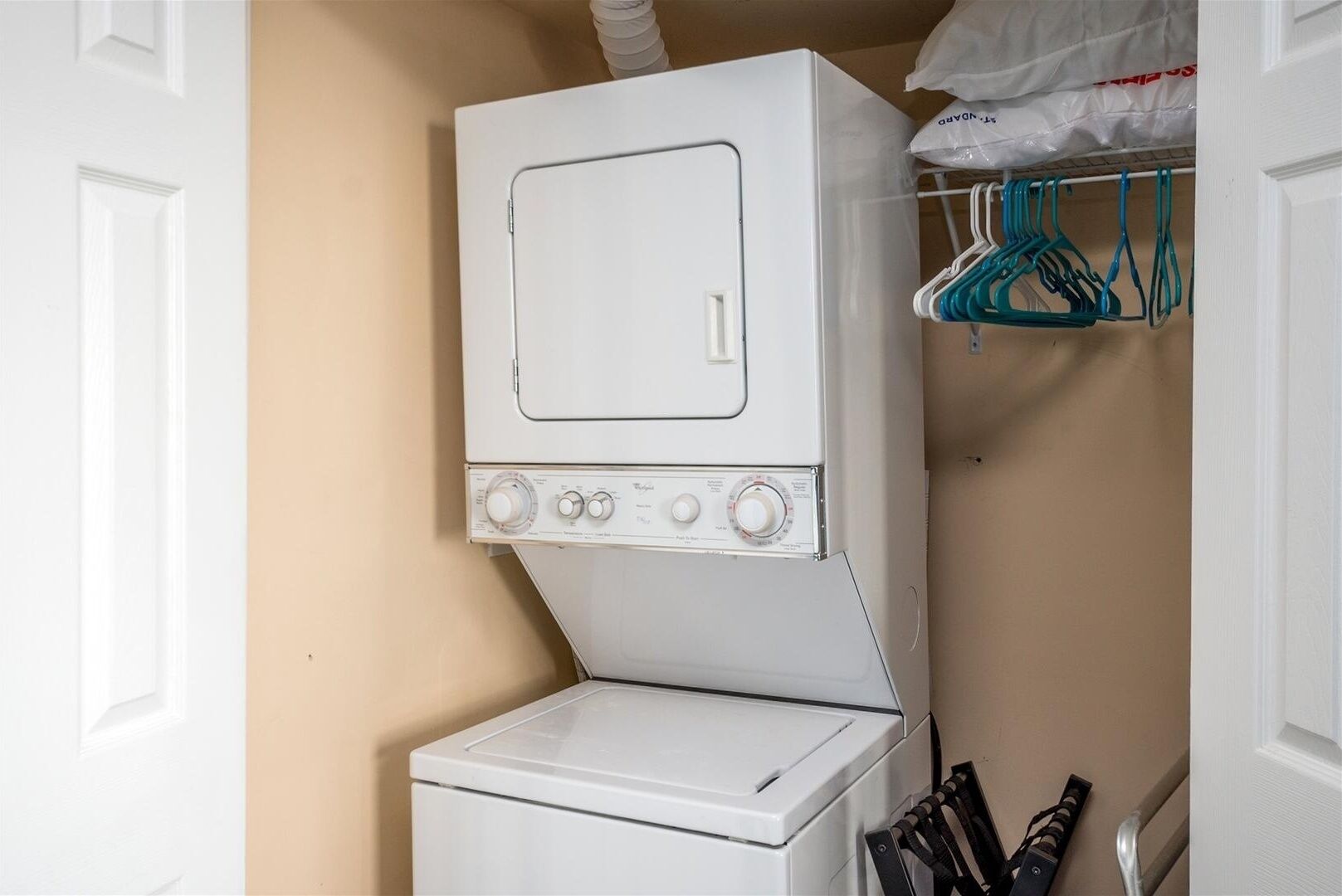 A compact laundry room with a washer and dryer stacked vertically.