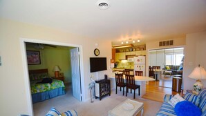 A compact living space with a bedroom, a dining area, and a kitchenette. - Club Ocean Villas Ii 19 2 Bedroom Condo by RedAwning (Ocean City)