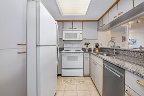Enjoy cooking in this well-equipped kitchen with a dishwasher, microwave, and sink.