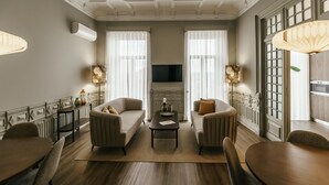 A living room with a fireplace, two sofas, a coffee table, and a TV.