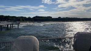 A pier extending into a body of water with a clear sky above. - Vacation home Fischerhuus on Usedom with sauna, fireplace and private garden (Zirchow)