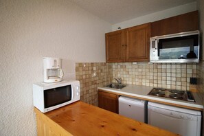 Prepare meals in this kitchen with a microwave, coffee maker, sink, and dishwasher.
