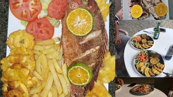 A plate with fried fish, fries, and a salad.