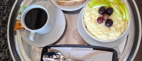 A meal tray with toast, scrambled eggs, and a cup of coffee.