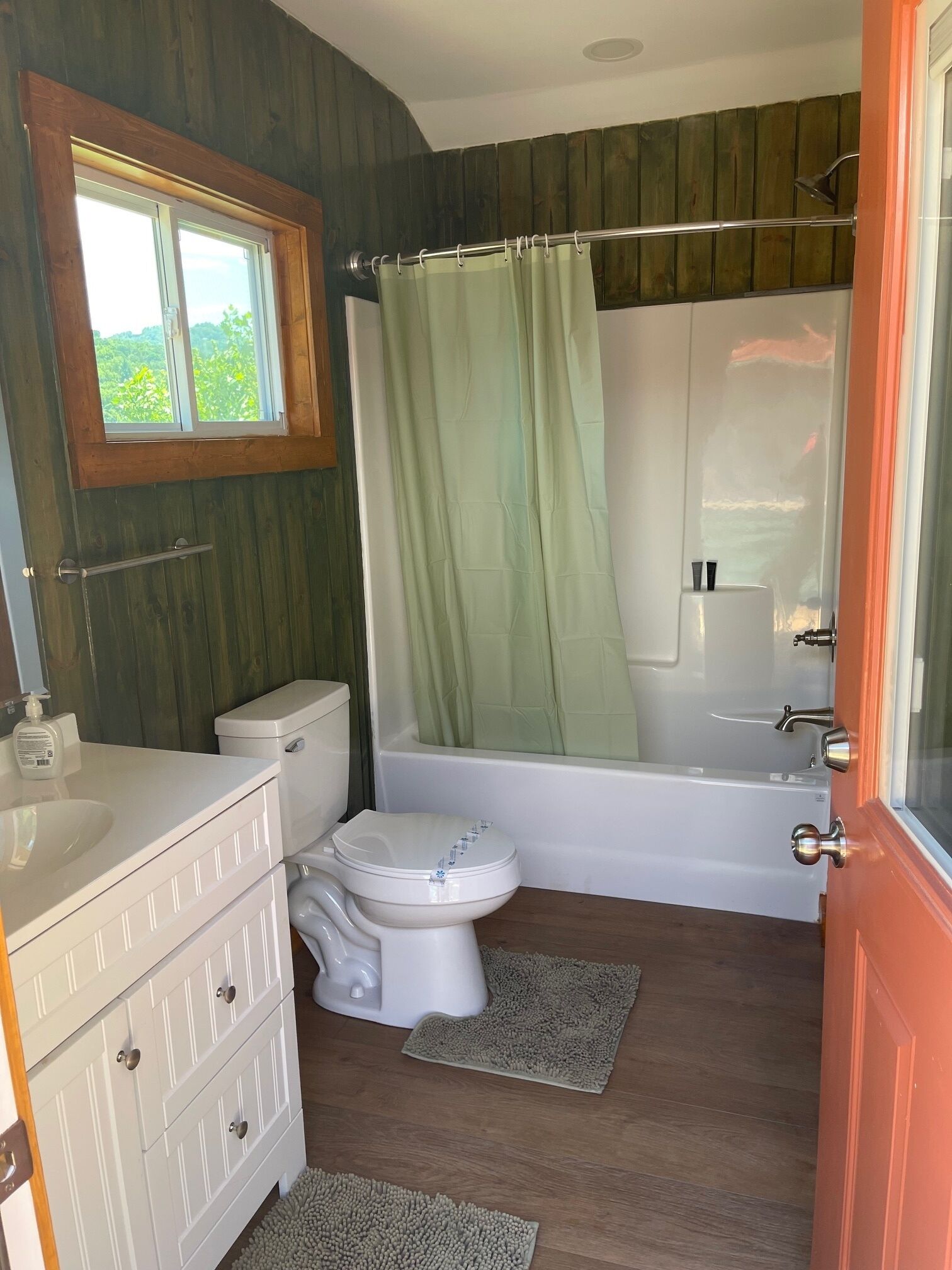 A bathroom with a toilet, sink, and bathtub.