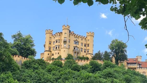 A castle-like building with multiple towers and balconies, surrounded by dense greenery. - 3-room vacation apartment in the Allgäu with garden and wood-burning stove (Leutkirch im Allgäu)