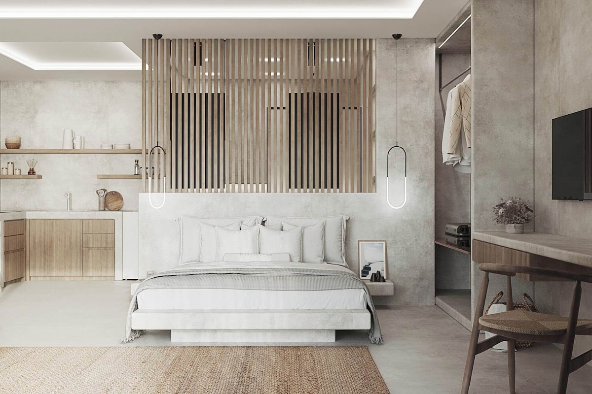 A modern bedroom with a bed, bedside tables, a desk, and a wardrobe.
