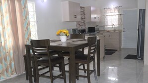 A modern kitchen with a dining area.