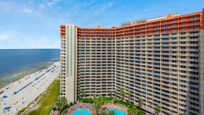 A high-rise hotel with a pool and beach view.