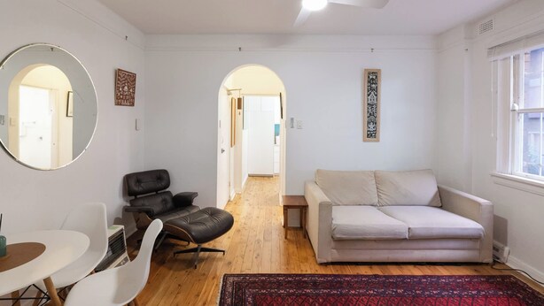 A living room with a ceiling fan, a sofa, a chair, a coffee table, and a rug. - Bondi local garden living, 5 mins walk to beach (Bondi Beach)