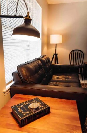 Relax in this inviting living area with a sofa, coffee table, and dining space.