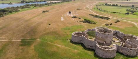 An aerial view of a historical site with ruins and a surrounding landscape.