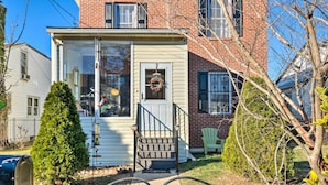 A small, single-story house with a front porch, a mailbox, and a wreath on the door. - 5 Mi to National Mall: Home in Washington DC (Washington)
