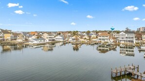 A waterfront residential area with houses, docks, and a clear sky.