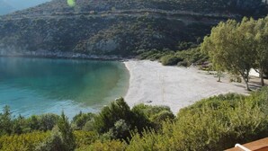 A coastal landscape with a beach, dense greenery, and a mountainous backdrop. - Secret Arkadia Bay Beachfront, Sea & mountain View, Secret Arkadia Bay Beachfront, Sea & mountain Vi (Arkadiko Chorio)