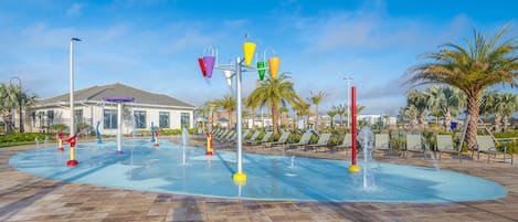 A water park with a pool, water slides, and lounge chairs.