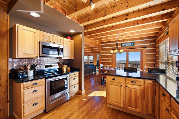 Enjoy cooking in this well-equipped kitchen with a large island, sink, and seating area.