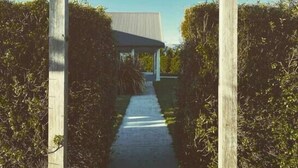 A wooden archway leading to a building with a sloped roof. - The York Residence in Hartley NSW - Newly Listed (Hartley)
