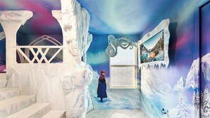 A room with a snowy landscape mural, a staircase, and a framed picture on the wall. - Grand 8BR Villa by Disney | Pool and Games Room (Kissimmee)