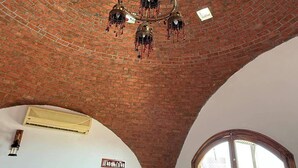 A room with a brick ceiling, a chandelier, a fan, and a window with a view. - Tala boutique accommodation 15 (Hurghada)