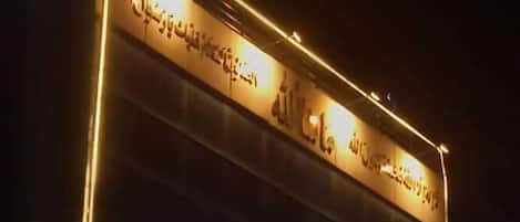 A hotel sign with "GRANDONE HOTEL" in illuminated letters.