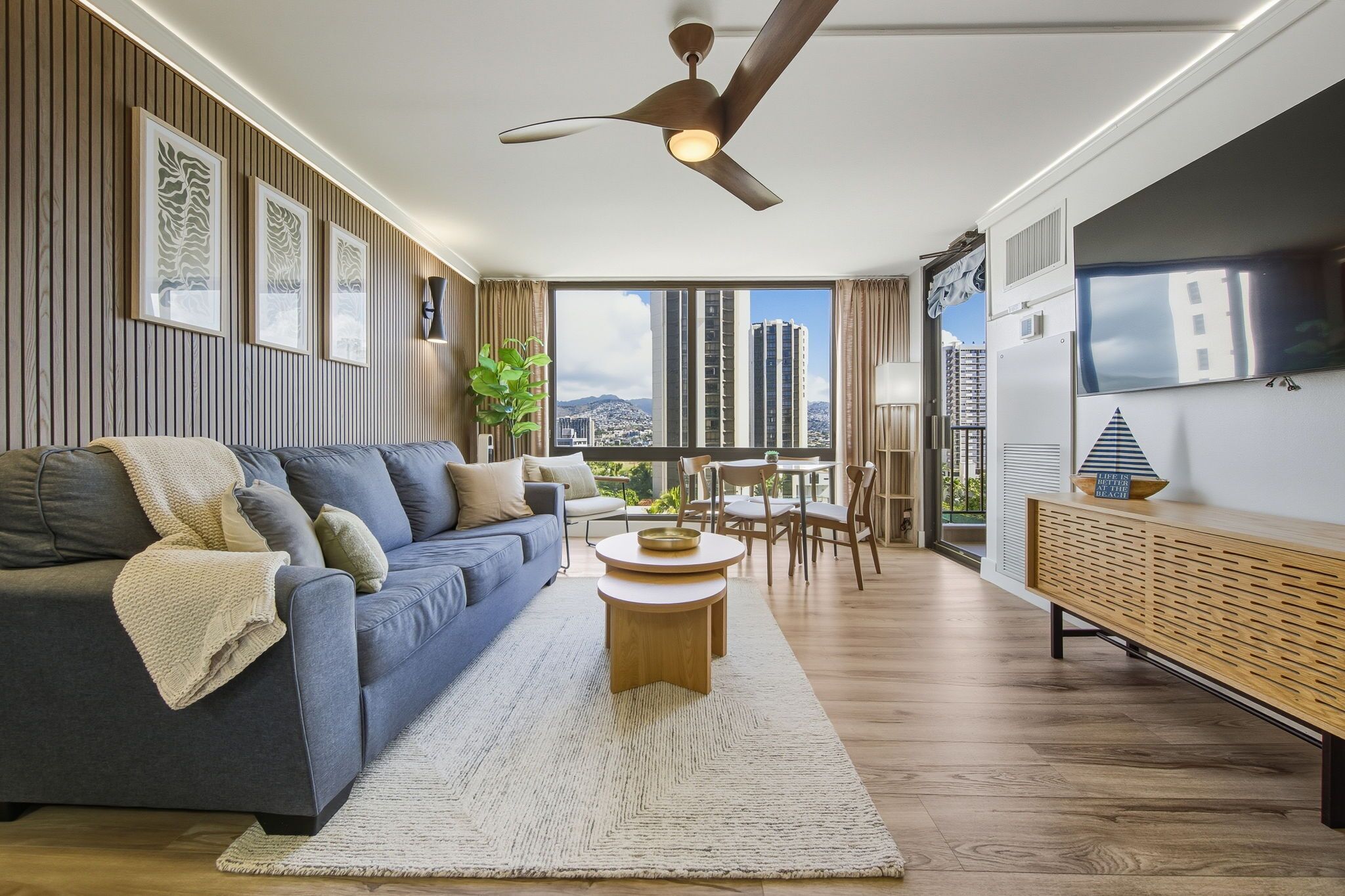 A modern living room with a sofa, coffee table, and TV.