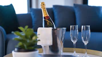 A bottle of Moรซt champagne, two glasses, and a small potted plant on a tray.