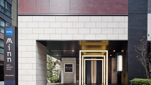 A modern hotel entrance with a prominent sign, a well-lit entrance, and a clean, tiled floor. - Minn Nihonbashi (Tokyo)