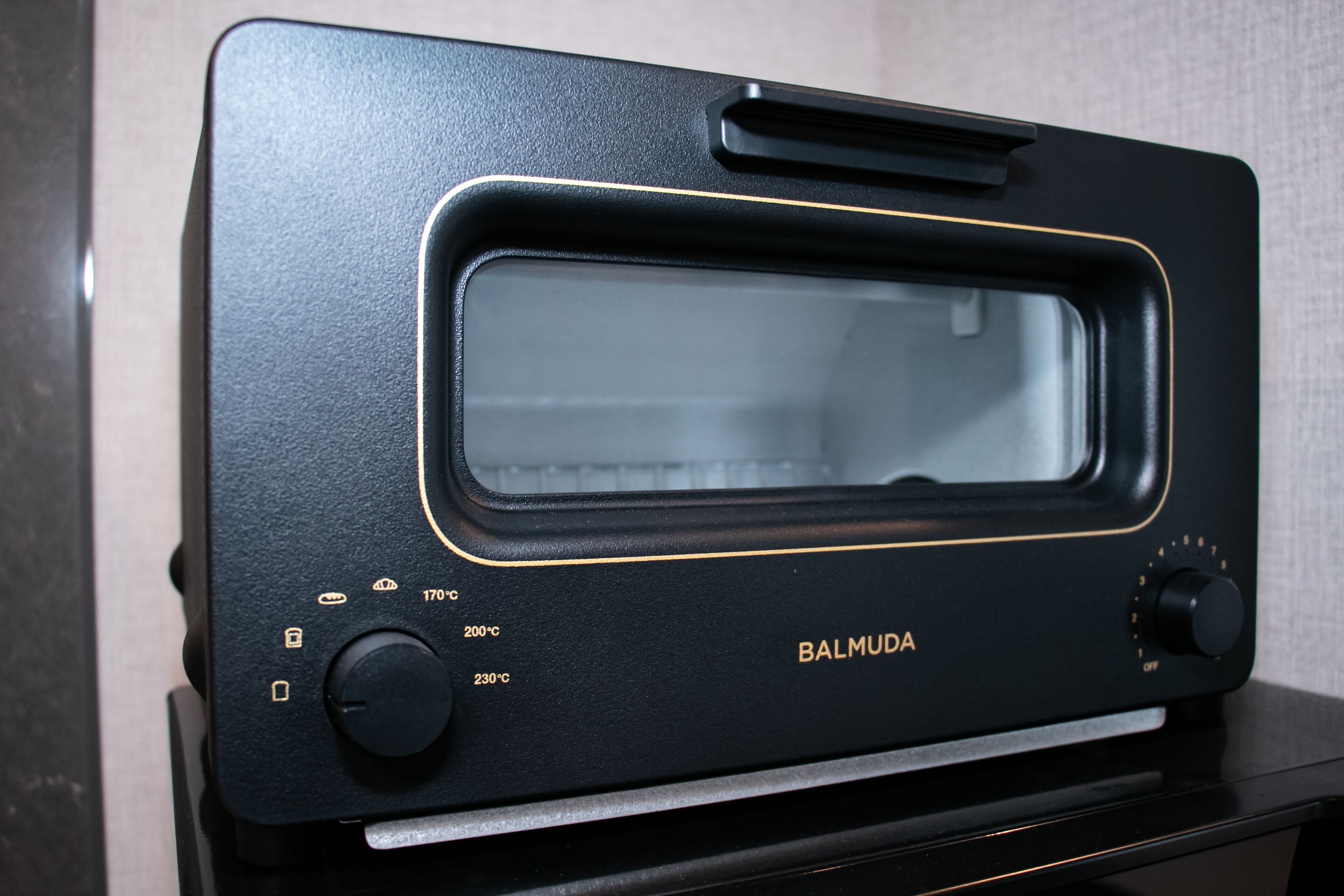 A black toaster oven with a digital display and temperature settings.