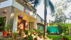 A building with a sign reading "DUNANAKIBARAN MILANO" and a balcony with potted plants. - Surya Kiran Miramar (Panaji)