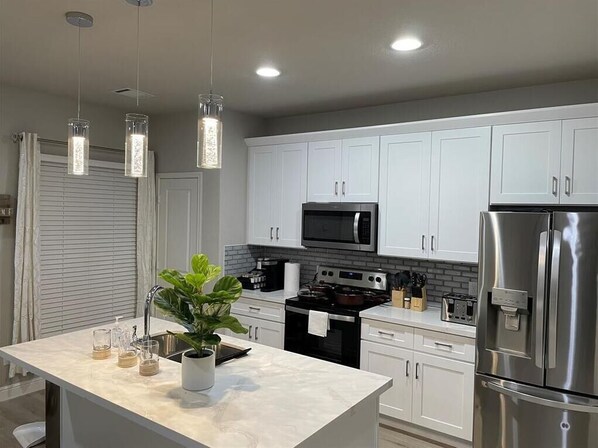 Enjoy cooking in this well-equipped kitchen with a stove, oven, microwave, and refrigerator.