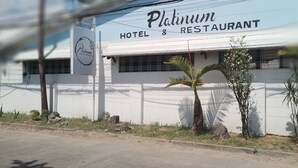 A Platinum Hotel & Restaurant with a white exterior and a signboard. - Platinum Hotel (Angeles City)