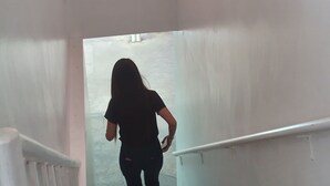 A person descending a staircase with white walls and a handrail. - Platinum Hotel (Angeles City)