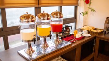 A breakfast bar with a coffee machine, a juice dispenser, and a tea dispenser.