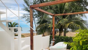 A modern outdoor bathroom with a wooden pergola, a white bathtub, and a view of the beach and ocean. - Cape by Sichon Tesoro (Sichon)