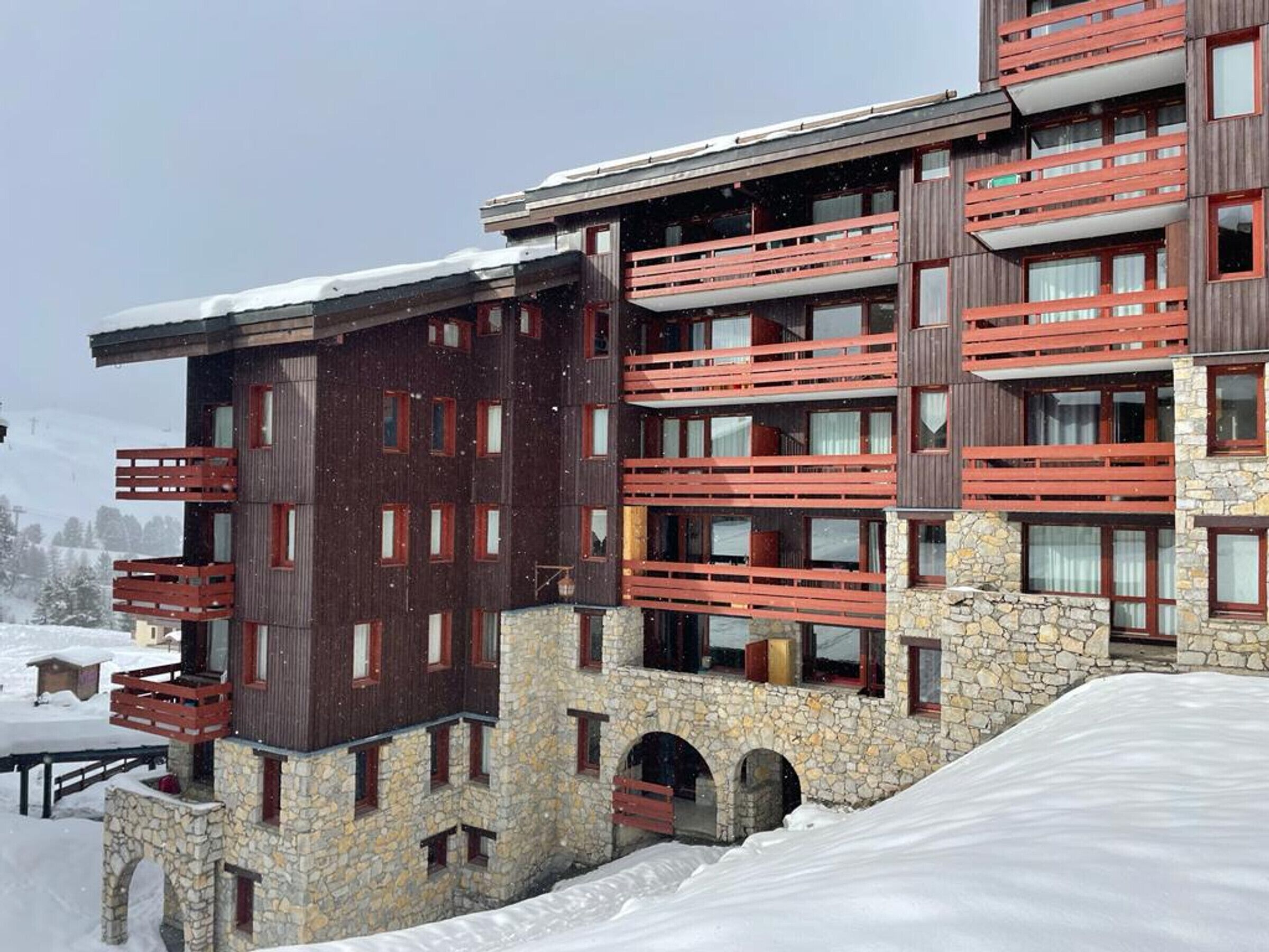 A multi-story hotel with balconies and stone architecture.