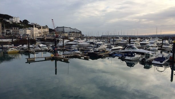 A marina with numerous boats docked, a crane, and buildings in the background. - Cosy Thatched Coastal Retreat, close to Maidencombe beach & beautiful pubs. (Stokeinteignhead Torquay)